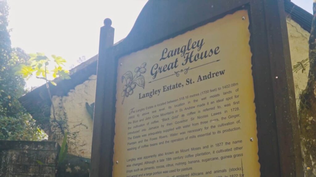 Informational sign of Langley Great House against a wall